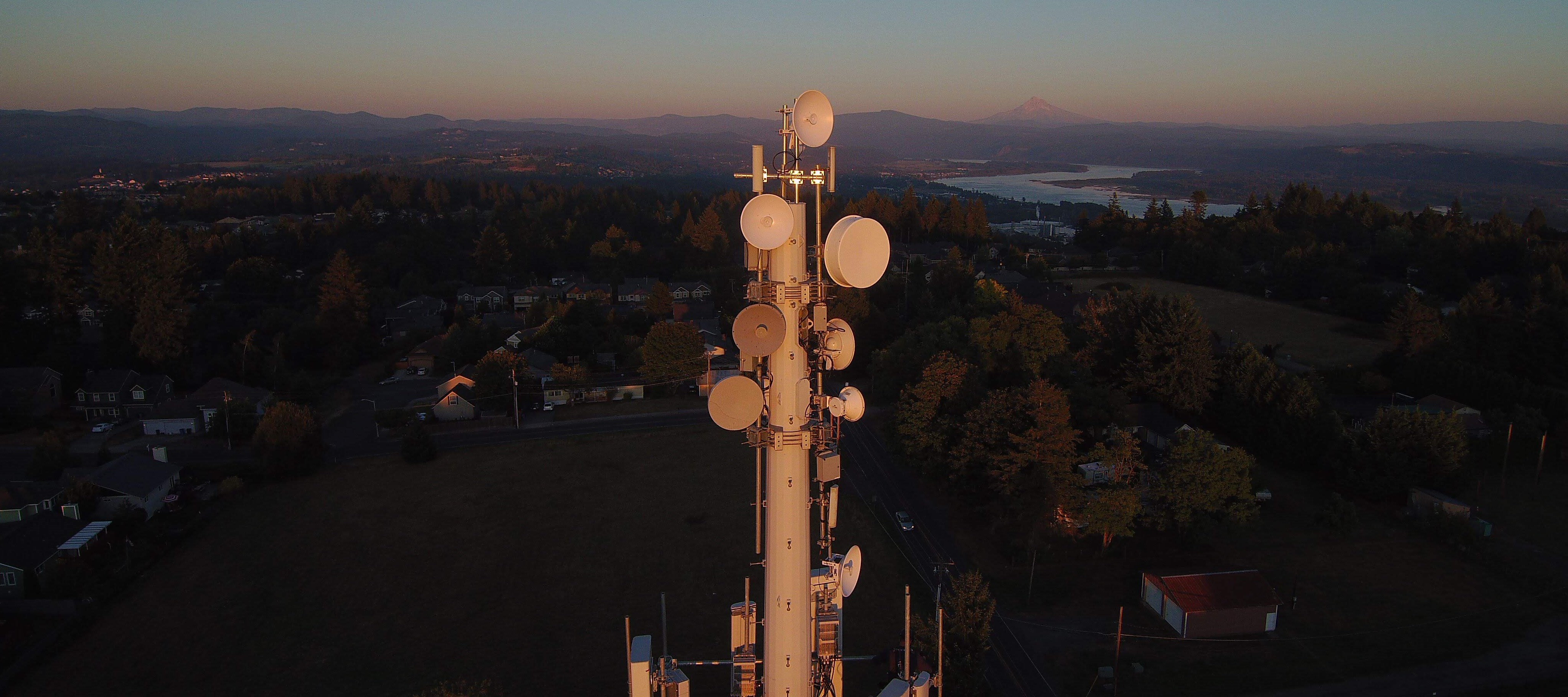 Image of a Radio Tower at sunset with Mount Hood in the background